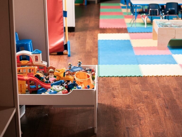 Child-friendly classroom with toys and play mats at Basic Model School